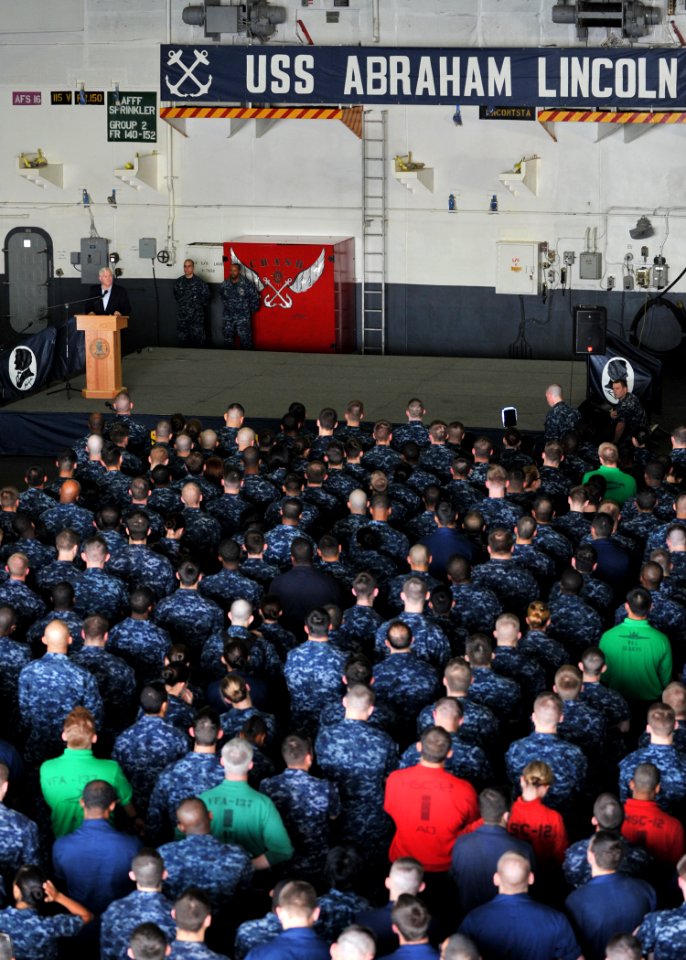 US Navy 101206-N-5016P-004 Secretary of Defense Robert M. Gates delivers remarks during an all-hands call aboard the aircraft carrier USS Abraham L