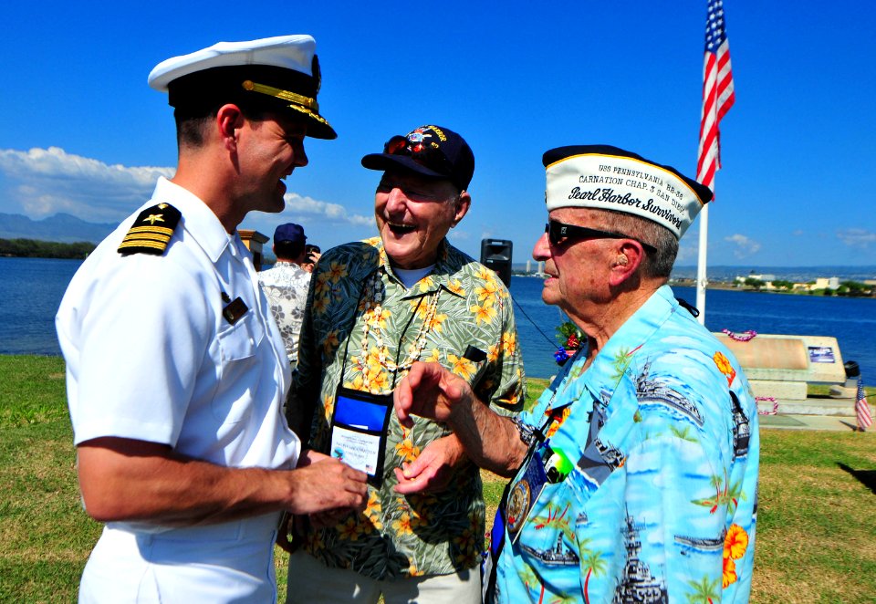 US Navy 101208-N-7948R-354 Cmdr. Homer R. Denius III, commanding officer of the amphibious dock landing ship USS Pearl Harbor (LSD 52), left, speak