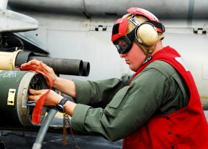 US Navy 101209-N-2218S-138 A Marine prepares a rocket pod aboard the amphibious assault ship USS Essex (LHD 2) for a live-fire exercise during Keen