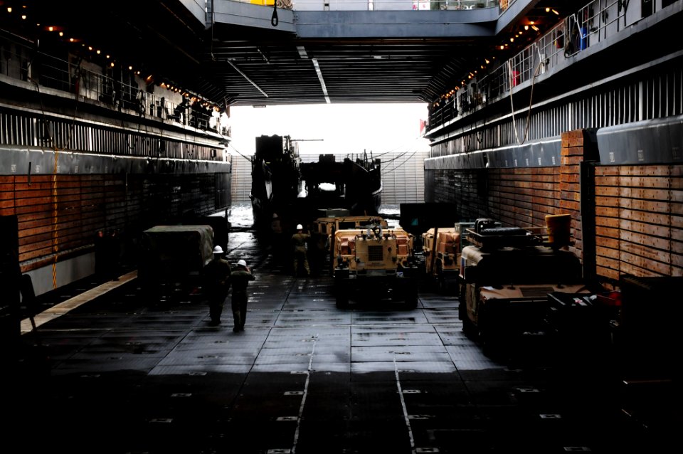 US Navy 101210-N-3659B-114 Marines position and load equipment on a landing craft utility in the well deck of USS Comstock (LSD 45)