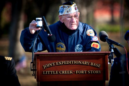 US Navy 101207-N-7874H-080 Frank Chebetar, president of the Tidewater Chapter 2 Pearl Harbor Survivors Association, holds a vile of oil recovered f