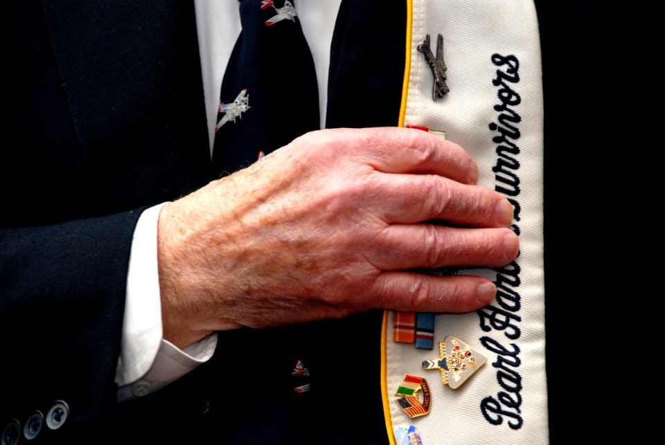 US Navy 101207-N-1251W-001 A survivor of the Dec. 7, 1941 Japanese attack on Pearl Harbor holds his cover over his heart during a Pearl Harbor Day
