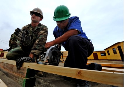 US Navy 101207-N-7589W-054 Builder 2nd Class Andras Toth, left, assigned to Naval Mobile Construction Battalion (NMCB) 28 photo