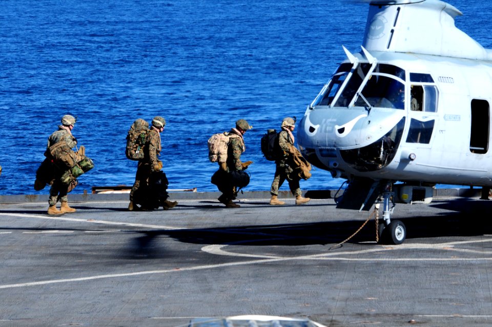 US Navy 101208-N-3659B-151 Marines approach a CH-46E Sea Knight helicopter aboard USS Comstock (LSD 45)
