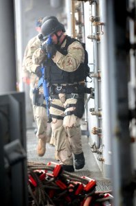 US Navy 101207-N-3659B-070 Sailors assigned to the visit, board, search and seizure team aboard USS Comstock (LSD 45) train on security practices photo