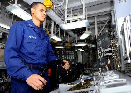 US Navy 101211-N-3154P-095 Machinist's Mate 3rd Class Shem Hutson stands the throttleman watch in a main machinery room aboard the amphibious assau