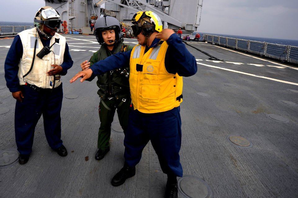 US Navy 101207-N-8335D-526 A Japan Maritime Self-Defense Force sailor speaks with U.S. Navy Sailors aboard the amphibious dock landing ship USS Tor