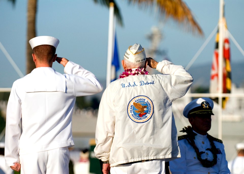 US Navy 101207-N-5476H-052 Art Herriford, right, president of the Pearl Harbor Survivors Association, salutes as Sailors aboard the guided-missile