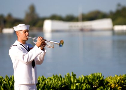 US Navy 101207-N-5476H-204 Musician 2nd Class Bryan Parmann, assigned to the U.S. Pacific Fleet Band, plays Taps during a ceremony commemorating th photo