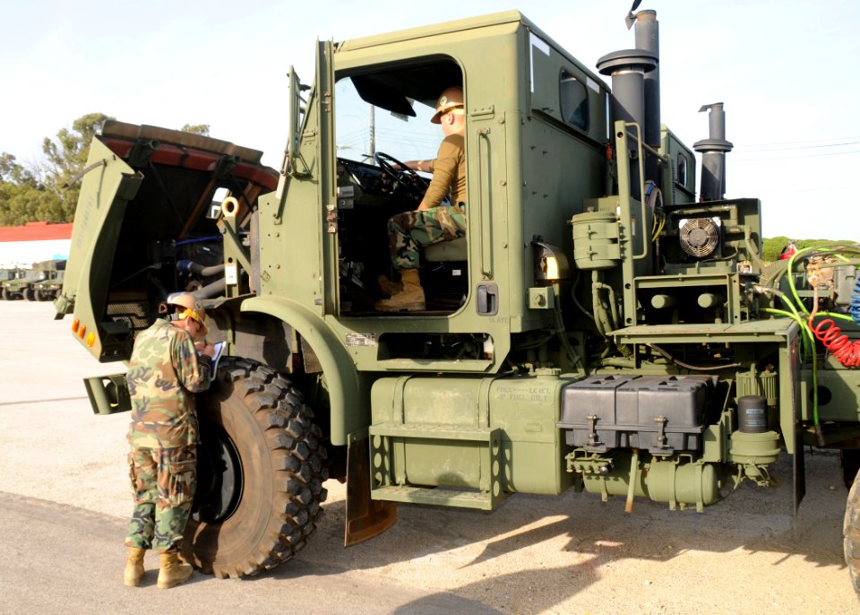 US Navy 101211-N-9564W-006 Equipment Operator Constructionman Steven Lott, right, assigned to Naval Mobile Construction Battalion (NMCB) 74, Alfa C
