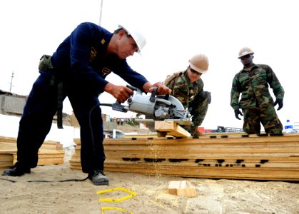 US Navy 101207-N-7589W-076 Equipment Operator 3rd Class John Guillenagudelo, center, assigned to Naval Mobile Construction Battalion (NMCB) 28, photo