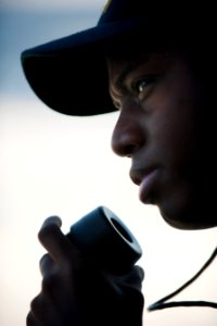 US Navy 101211-N-7981E-118 Yeoman Seaman Tyrone Thompkins reports on a sound-powered phone while standing watch as a lookout on the fantail of USS
