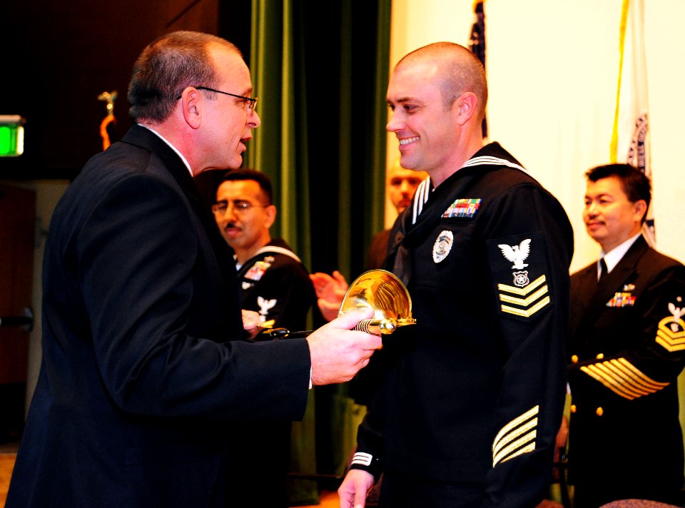 US Navy 101209-N-7526R-036 Command Master Chief Robert L. White, assigned to Commander Navy Region Europe, Africa, Southwest Asia, presents Master