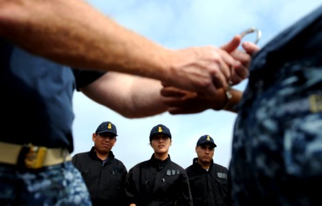 US Navy 101209-N-2984R-790 Peruvian sailors observe proper handcuffing techniques during a week-long training provided by a security subject matter photo
