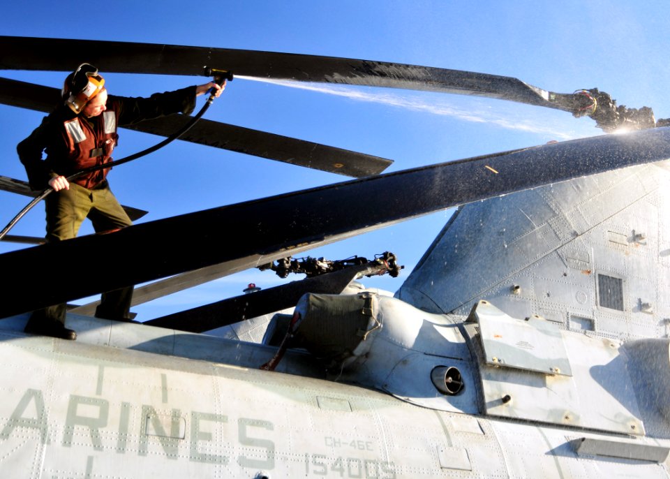 US Navy 101208-N-1722W-026 Sgt. Jessica Tracey washes a CH-46E Sea Knight helicopter uring regularly scheduled maintenance aboard USS Boxer (LHD 4)