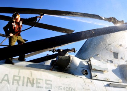 US Navy 101208-N-1722W-026 Sgt. Jessica Tracey washes a CH-46E Sea Knight helicopter uring regularly scheduled maintenance aboard USS Boxer (LHD 4)