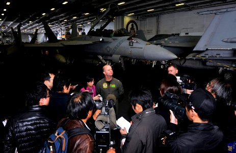 US Navy 101209-N-7103C-161 Capt. Ross Myers speaks with embarked Japanese reporters in the hangar bay aboard USS George Washington (CVN 73)