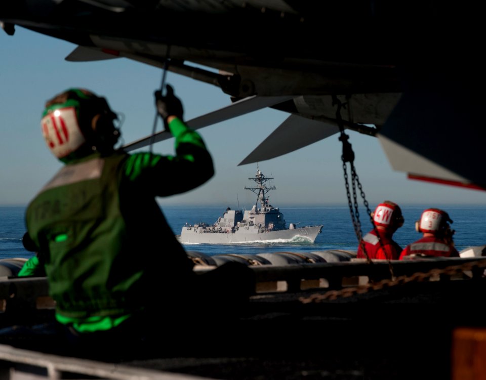 US Navy 101212-N-7981E-162 Squadron maintenance personnel and aviation ordnancemen work on the flight deck of the aircraft carrier USS Carl Vinson