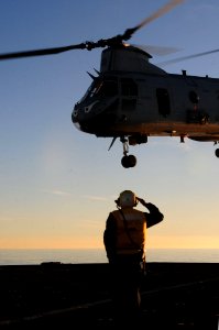 US Navy 101213-N-3659B-056 Boatswain's Mate 1st Class Adam Cohen, from Bradley Beach, N.J., salutes the aircrew of a CH-46E Sea Knight helicopter