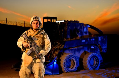 US Navy 101213-N-6436W-124 Construction Mechanic 3rd Class Ty Ramsey poses for a portrait at the end of a workday at combat outpost Khavajeh Molk A
