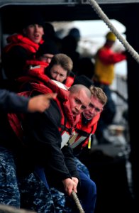US Navy 101214-N-6006S-038 Sailors aboard the guided-missile cruiser USS Bunker Hill (CG 52) heave lines during a replenishment at sea with the Mil