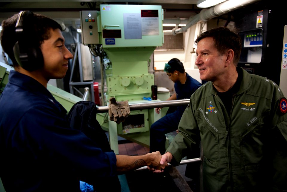 US Navy 101214-N-7981E-226 Vice Adm. Allen G. Myers meets Machinist's Mate 3rd Class Taylor Fenton while touring the waste processing room aboard U