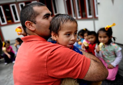 US Navy 101210-N-2984R-635 Electronics Technician 1st Class Joel Eyzaguirre hugs his godson after an arranged meeting at the Johannes Gutenberg Sch