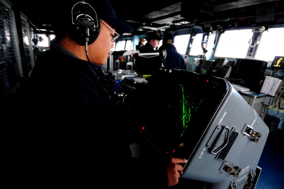 US Navy 101210-N-3659B-019 Operations Specialist 3rd Class Marisol Caceres watches the SPA-25G radar console while serving as the JL phone talker o