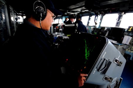 US Navy 101210-N-3659B-019 Operations Specialist 3rd Class Marisol Caceres watches the SPA-25G radar console while serving as the JL phone talker o