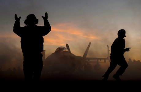US Navy 101211-N-7981E-367 An aircraft director guides an F-A-18F Super Hornet assigned to Strike Fighter Squadron (VFA) 22 after making an arreste