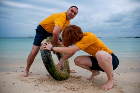 US Navy 101212-N-5758H-005 Musician 1st Class Brian Nefferdorf, left, and Musician 3rd Class Catherine Chauvot remove a tire from the bay at Painag