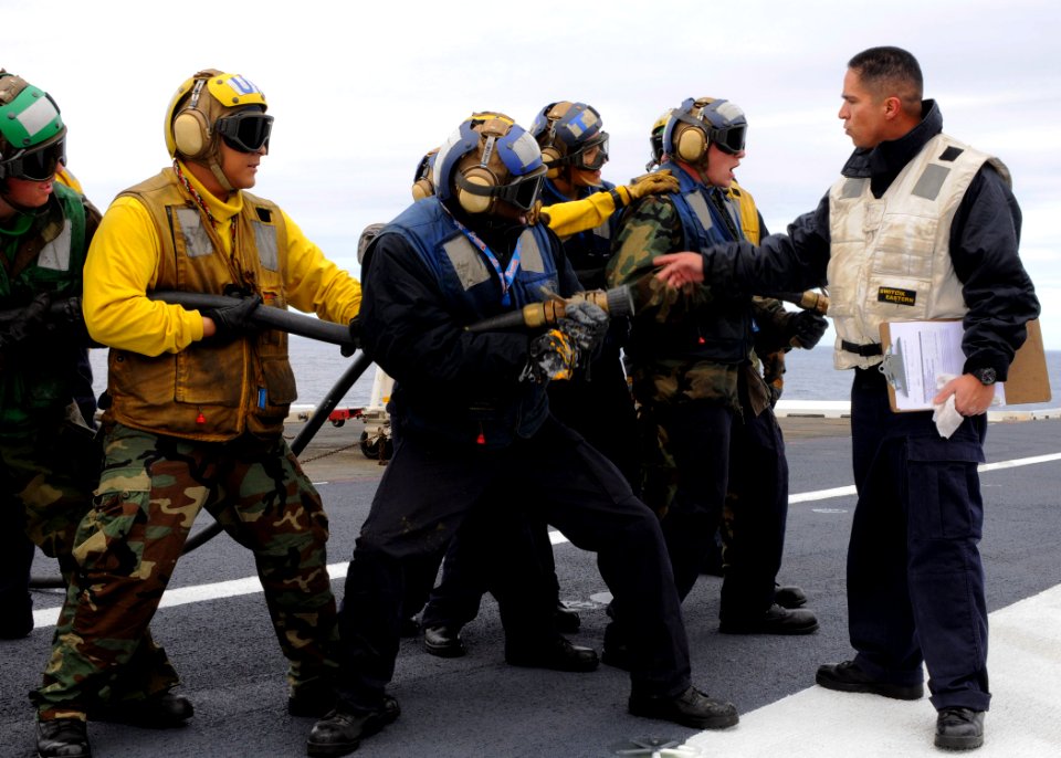 US Navy 101216-N-4590G-015 Aviation Boatswain's Mate (Handling) 1st Class Enrique Talavera instructs Sailors during a firefighting drill