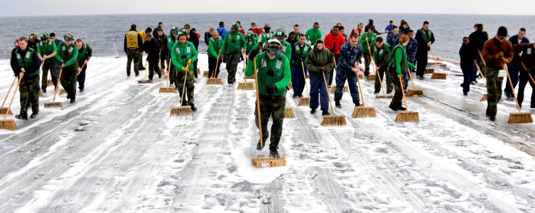 US Navy 101213-N-7103C-116 Sailors scrub the flight deck during a countermeasure wash down aboard USS George Washington (CVN 73)
