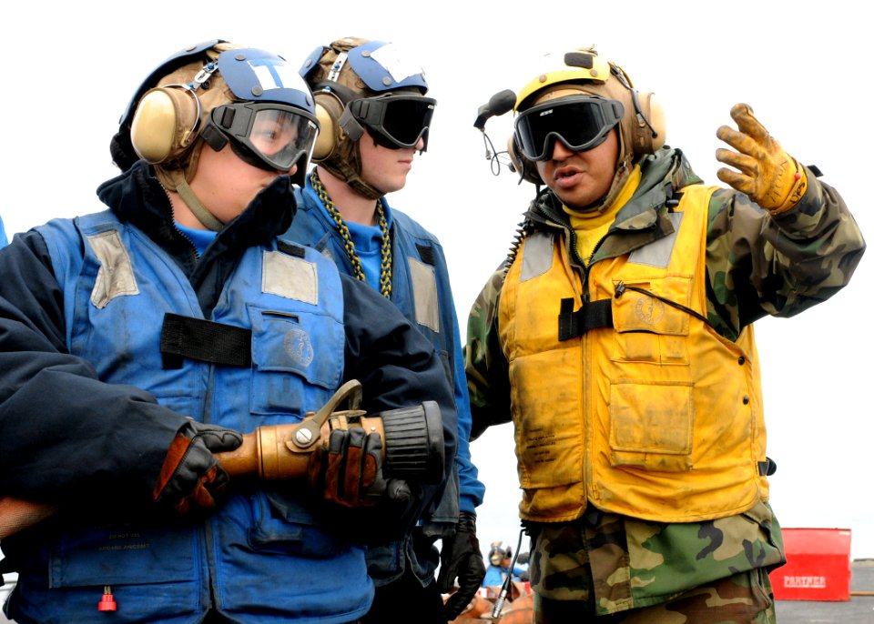 US Navy 101216-N-4590G-052 Aviation Boatswain's Mate (Handling) 3rd Class David Sanchez instructs Sailors during a firefighting drill