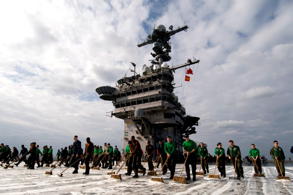 US Navy 101213-N-7191M-054 Sailors scrub the flight deck during a countermeasure wash down aboard USS George Washington (CVN 73)