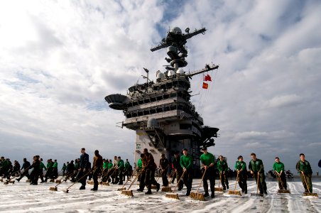 US Navy 101213-N-7191M-054 Sailors scrub the flight deck during a countermeasure wash down aboard USS George Washington (CVN 73)
