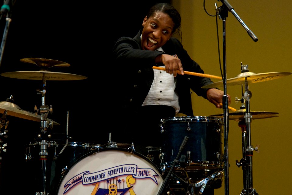 US Navy 101212-N-5758H-043 Musician 3rd Class Camellia Akhami plays the drums during the U.S. 7th Fleet Band, Far East Edition's Friendship Concert