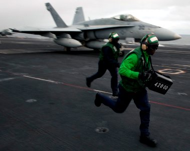 US Navy 101217-N-7981E-093 Aviation Boatswain's Mate (Equipment) Airman Terrance Chase displays the weight of an F-A-18C Hornet