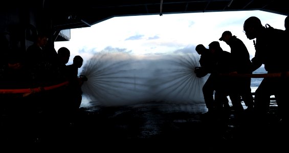 US Navy 101214-N-2475A-134 Sailors handle hoses during a live hose training in the hangar bay aboard USS John C. Stennis (CVN 74)