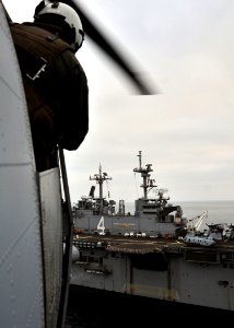 US Navy 101214-N-1722W-137 A Marine assigned to the Evil Eyes of Marine Medium Helicopter Squadron (HMM) 163 observes the flight deck as a CH-46E S
