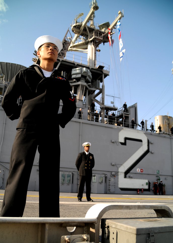 US Navy 101214-N-0120A-273 Logistics Specialist 3rd Class Brian Varilla mans the rails aboard the forward-deployed amphibious assault ship USS Esse
