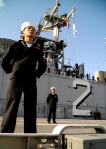 US Navy 101214-N-0120A-273 Logistics Specialist 3rd Class Brian Varilla mans the rails aboard the forward-deployed amphibious assault ship USS Esse