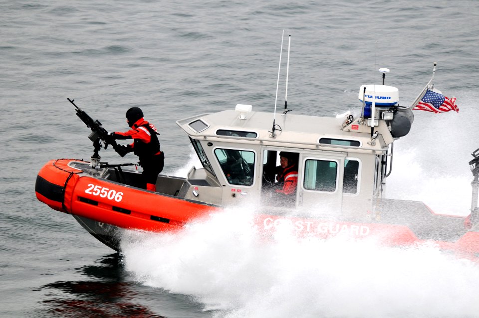 US Navy 101215-N-0232G-100 U.S. Coast Guardsmen aboard a security patrol craft escort the aircraft carrier USS Ronald Reagan (CVN 76) out of San Di