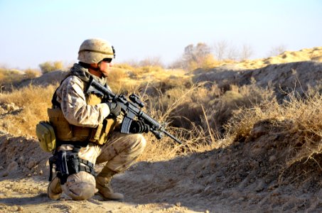 US Navy 101218-N-6436W-036 Marine Corps Gunnery Sgt. Javier Vega pauses for a security halt while conducting perimeter security checks around a ne