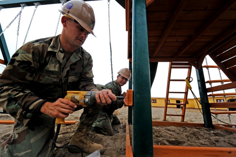 US Navy 101214-N-7589W-037 Builder 2nd Class Andras Toth, left and Equipment Operator 3rd Class John Guillenagudelo, both assigned to Naval Mobile