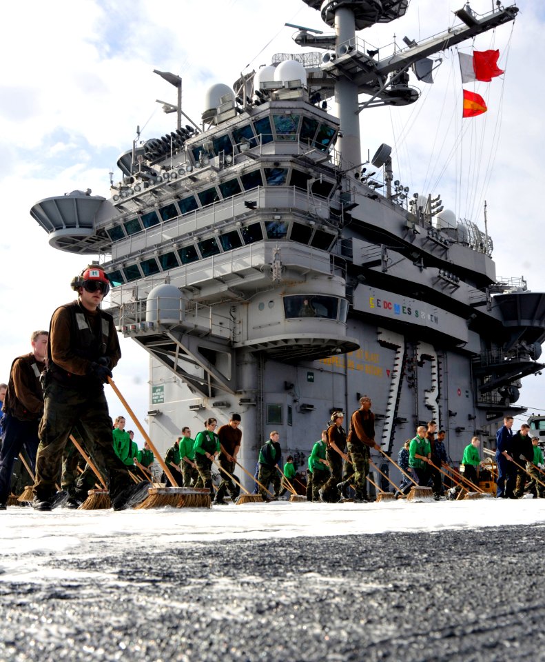 US Navy 101213-N-7103C-185 Sailors scrub the flight deck during a countermeasure wash down aboard USS George Washington (CVN 73)