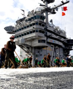 US Navy 101213-N-7103C-185 Sailors scrub the flight deck during a countermeasure wash down aboard USS George Washington (CVN 73) photo