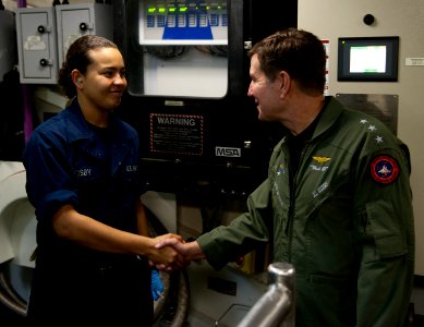 US Navy 101214-N-7981E-188 Vice Adm. Allen G. Myers meets Hull Technician Fireman Jesseca Crosby while touring the waste processing room aboard USS