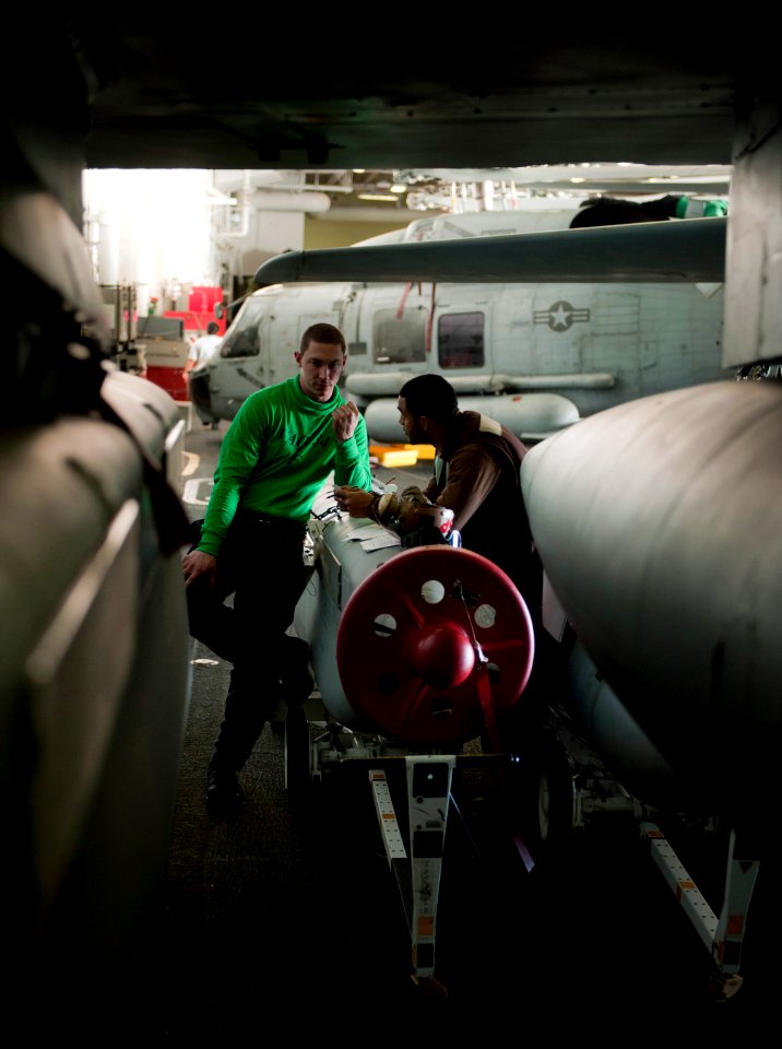 US Navy 101213-N-7981E-520 Aviation Structural Mechanic Airman Colin Scott, left, and Aviation Machinist's Mate 3rd Class Joshua Lee quiz each othe