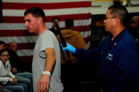 US Navy 101215-N-3659B-120 Logistics Specialist 2nd Class Lourdevan Timtiman uses a metal detector to search a Marine during a noncombatant evacuat